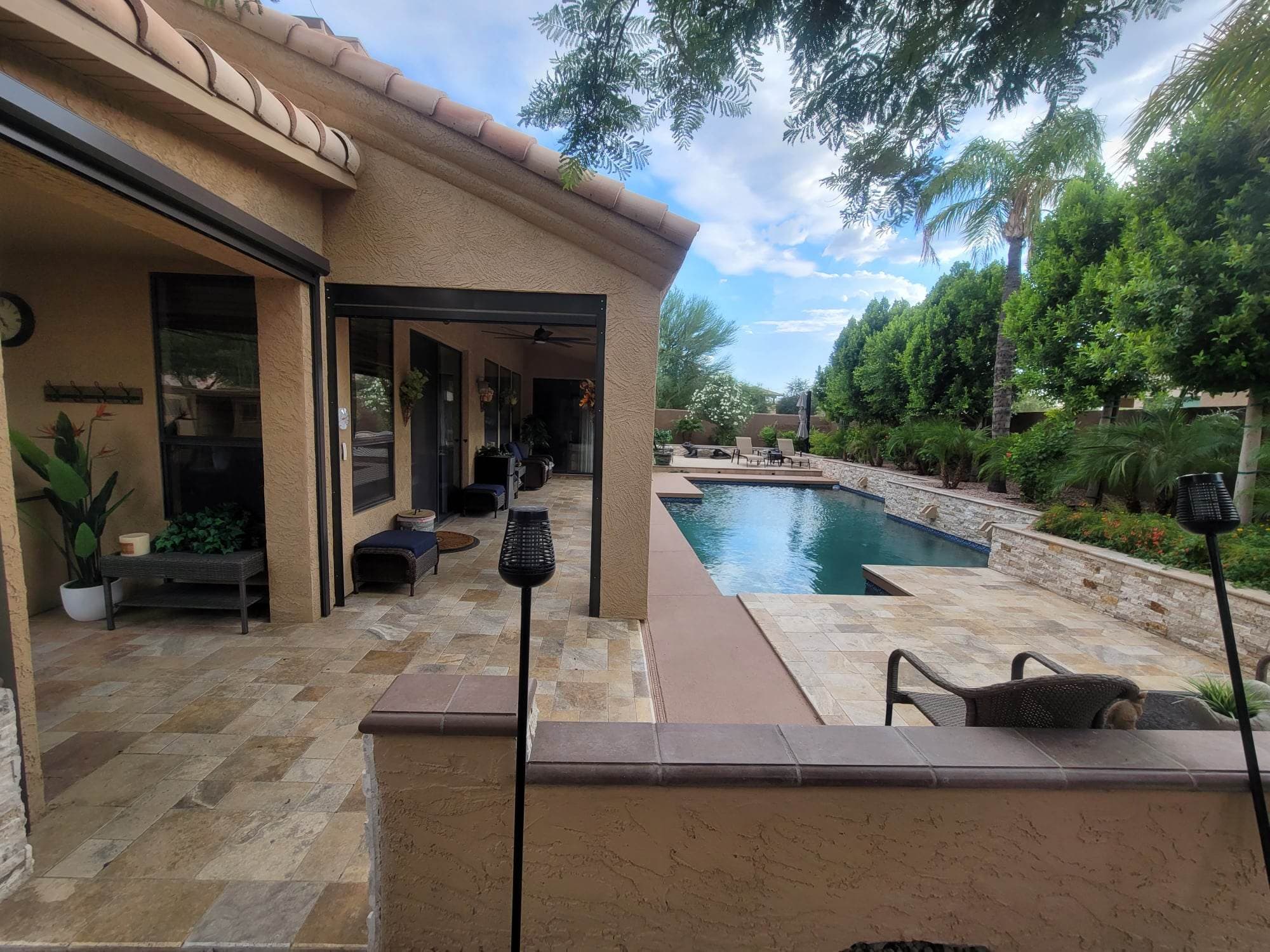 Finished covered patio with wood ceiling and tiled floor
